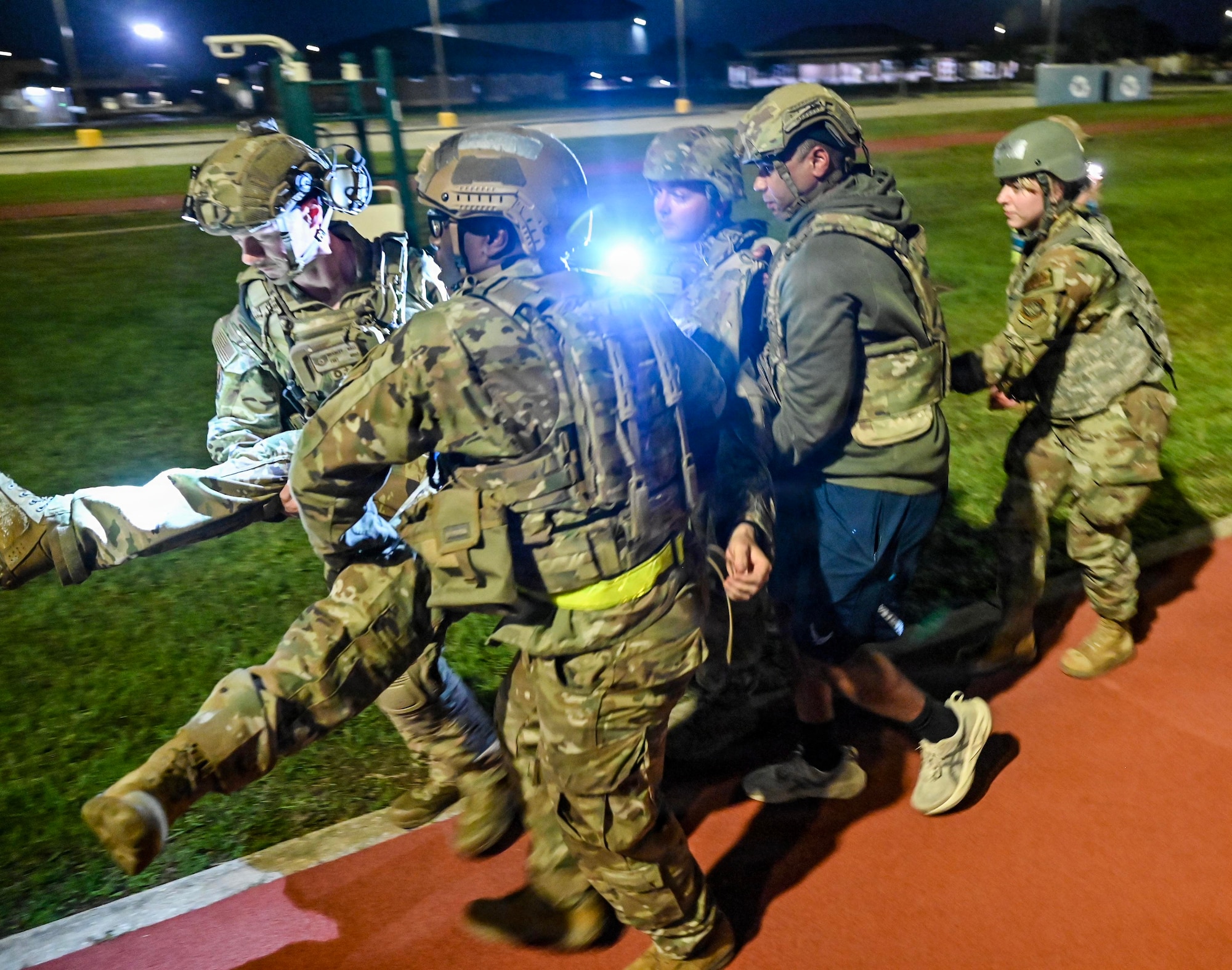 Military members carry another member.