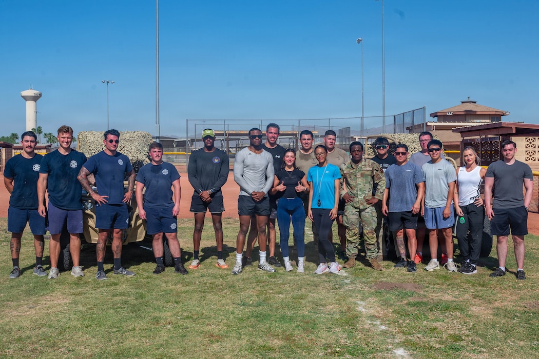 U.S. Airmen assigned to the 56th Security Forces Squadron and 56th Civil Engineer Squadron pose for a group photo at the end of the defenders challenge held during 2026 Police Week at Luke Air Force Base, Arizona, May 11, 2026. The event aligned with National Police Week 2026, an annual event observed by civilian and military law enforcement entities to honor tradition, precision, and the spirit of service of law enforcement members in support of the partnerships and communities they serve. (U.S. Air Force photo by Airman 1st Class Tekorey Watkins)