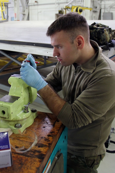 Technician working on a small item.