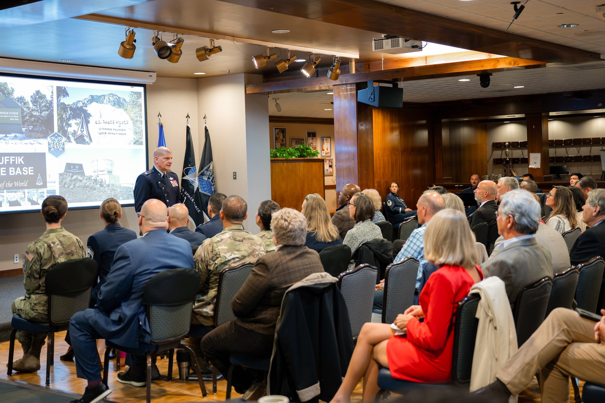 Col. Klock stands in front of an audience while addressing them.
