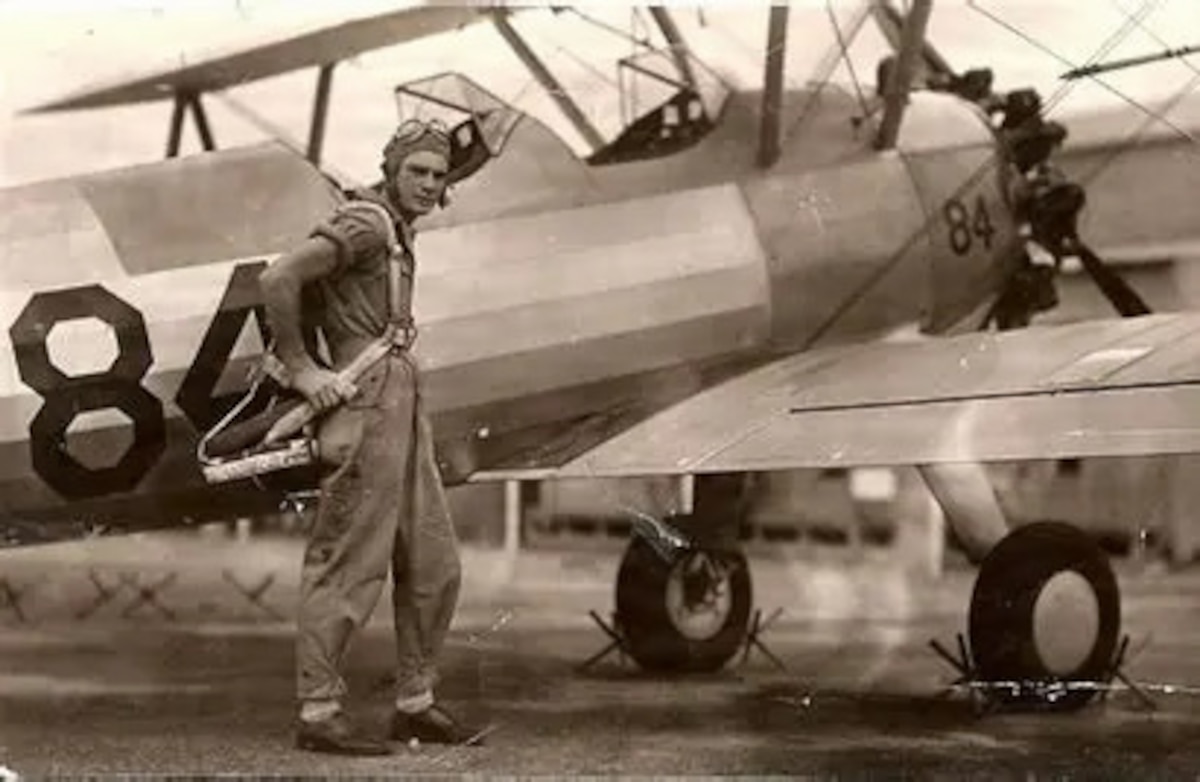 Person standing outside of an airplane.