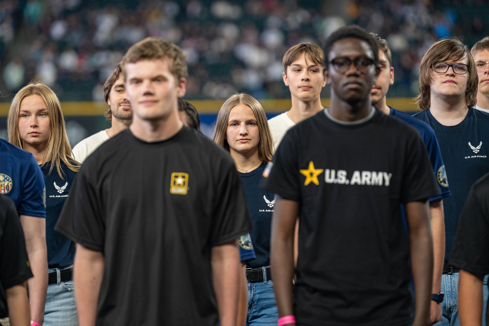 A group of people stand close together.