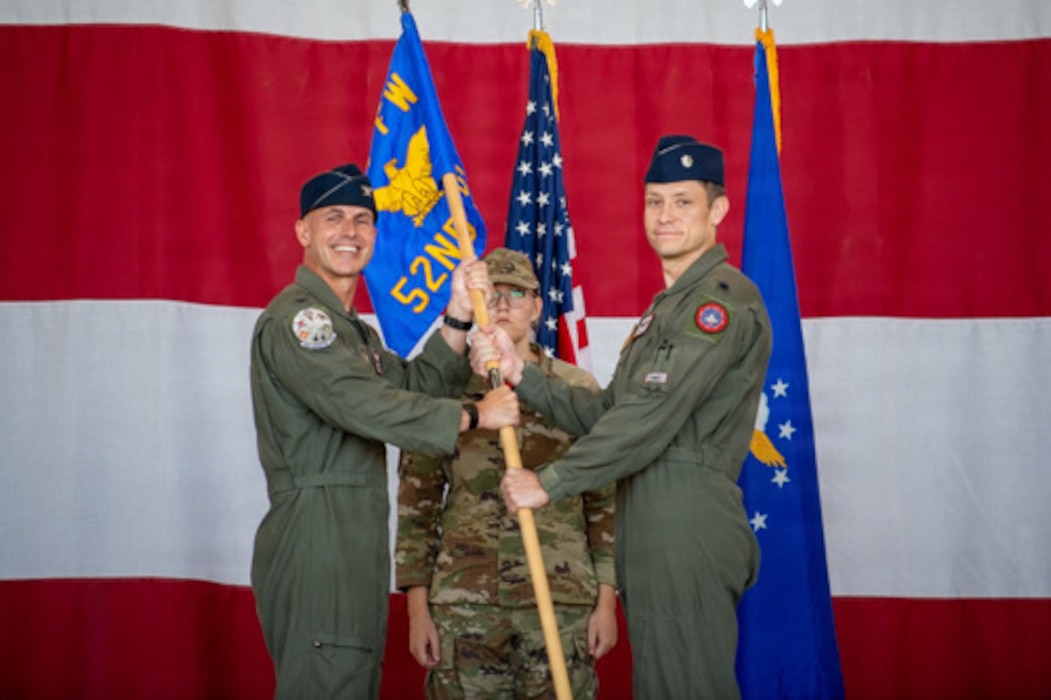 U.S. Air Force Reserve Col. Peter Cossette, 944th Operations Group commander, passes the guidon to Lt. Col. Dan Westendorf during a 52nd Fighter Squadron change of command ceremony in Hangar 999 at Luke Air Force Base, Ariz., May 15, 2026. The ceremonial passing of the guidon signifies the formal transfer of command authority to the incoming squadron commander.
(U.S. Air Force photo by Tech. Sgt. Tricia C.