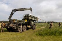 U.S. Marines with 3rd Battalion, 12th Marine Regiment, load a rocket pod onto a High Mobility Artillery Rocket System to conduct live fire missions during a live fire training event at the Combined Arms Training Center, Camp Fuji, Japan, May 20, 2026.