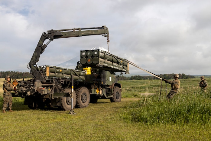 U.S. Marines with 3rd Battalion, 12th Marine Regiment, load a rocket pod onto a High Mobility Artillery Rocket System to conduct live fire missions during a live fire training event at the Combined Arms Training Center, Camp Fuji, Japan, May 20, 2026.