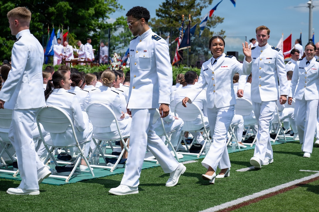 A U.S. Coast Guard Academy (USCGA) cadet waves at her family during the 145th Commencement Exercises at the Coast Guard Academy, New London, Connecticut, May 20, 2026. USCGA commissioned 266 officers from the class of 2026. (U.S. Coast Guard photo by Petty Officer 3rd Class Rajesh Harrilal)