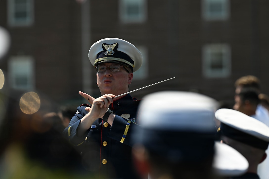 Chief Warrant Officer Jeffrey Spenner conducts the U.S. Coast Guard Band during the U.S. Coast Guard Academy graduation ceremony in New London, Connecticut, May 20, 2026. The ceremony marked the 145th commencement exercises for the academy. (U.S. Coast Guard photo by Petty Officer 3rd Class Lyric Jackson)