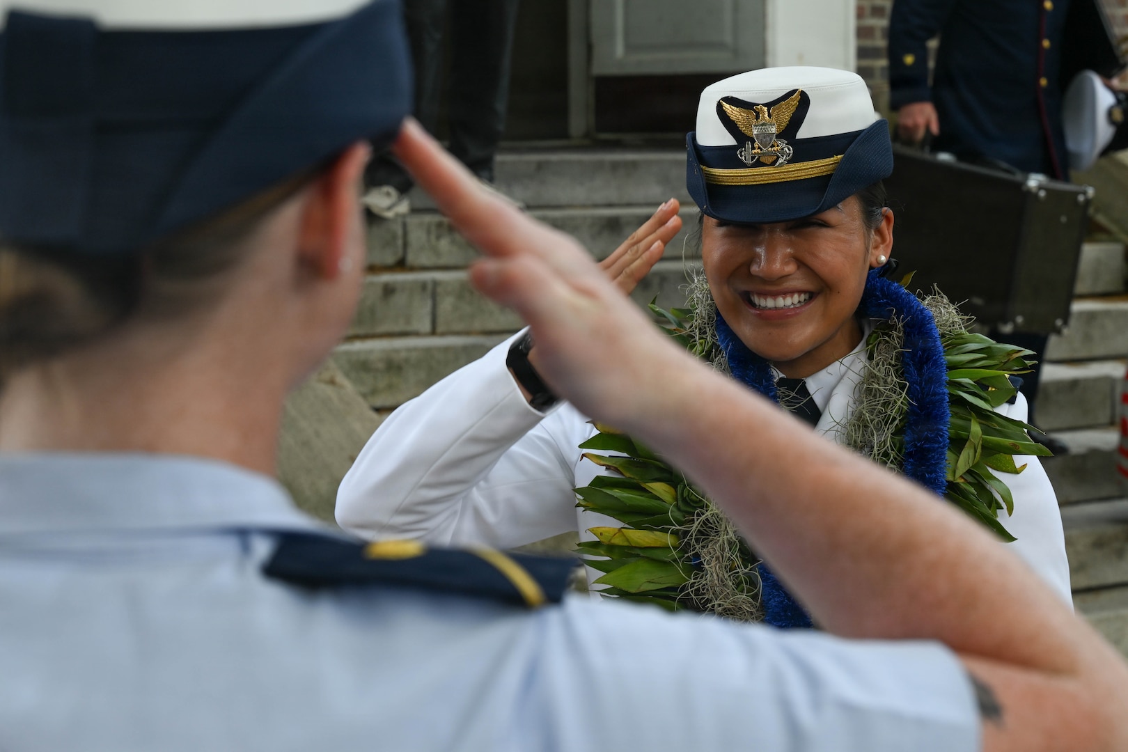 Ensign Tealani Wasson renders her first salute to a friend following the U.S. Coast Guard Academy graduation ceremony in New London, Connecticut, May 20, 2026. The first salute is a military tradition recognizing a newly commissioned officer’s entry into service.