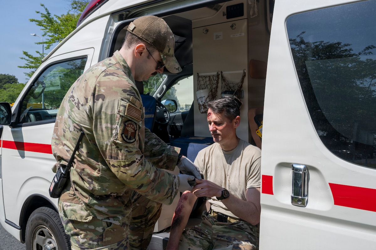 U.S. Air Force Staff Sgt. Connor O’Donnell, left, 35th Healthcare Operations Squadron paramedic, simulates first responder field treatment with Master Sgt. Raphael Duralde, 35th Fighter Wing office of the Inspector General chief of complaints resolution, during an active shooter exercise at Misawa Air Base, Japan, May 18, 2026.