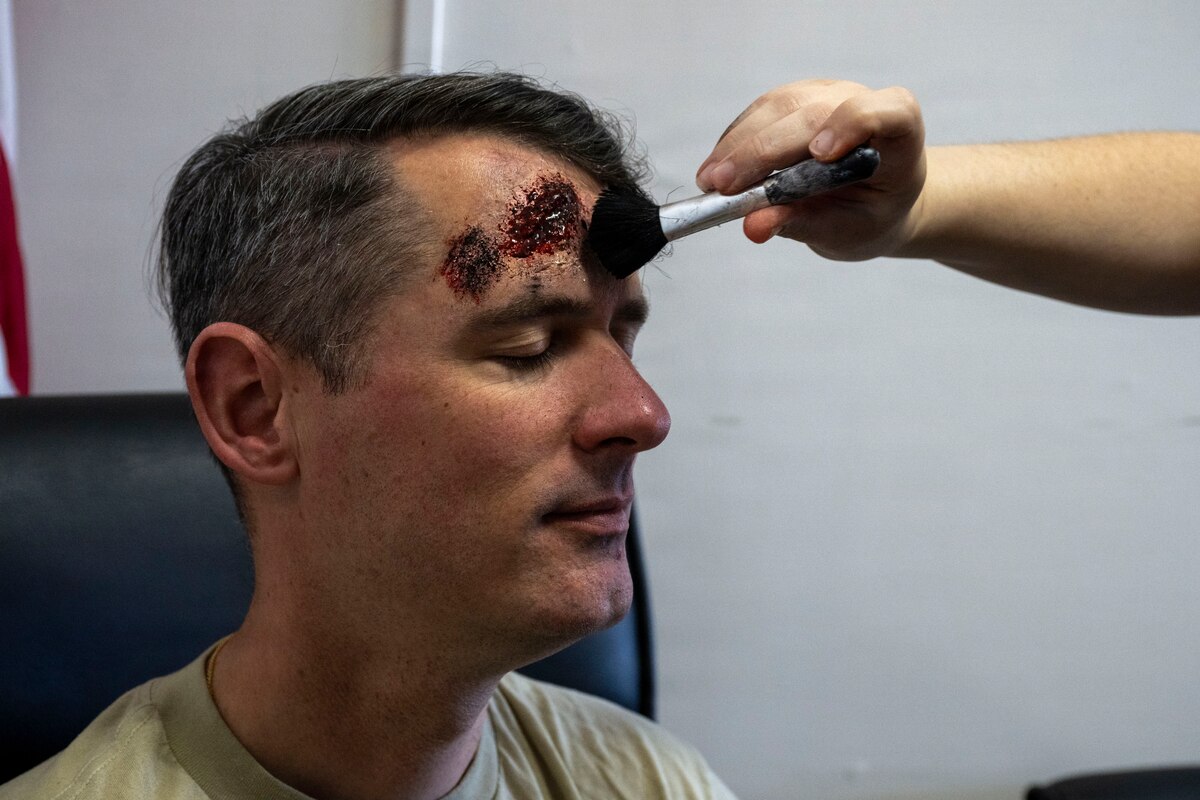 U.S. Air Force Master Sgt. Raphael Duralde, 35th Fighter Wing office of the Inspector General chief of complaints resolution, receives moulage makeup as a casualty actor before the start of an active shooter exercise at Misawa Air Base, Japan, May 18, 2026.