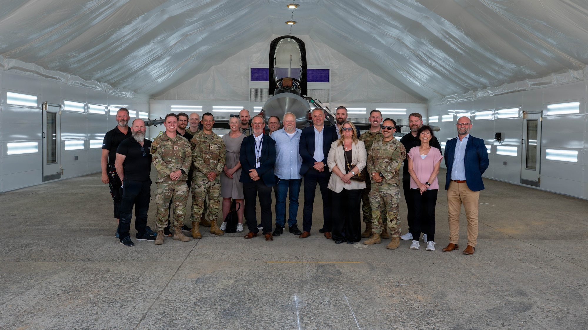 U.S. Air Force personnel and civilian partners pose for a group photo following a ribbon cutting ceremony for a new deployable corrosion prevention and control facility at Osan Air Base, Republic of Korea, May 18, 2026. The facility supports combat readiness by enabling corrosion control operations to be completed on station rather than at off-site locations. (U.S. Air Force photo by Airman 1st Class Megan Cusmano)