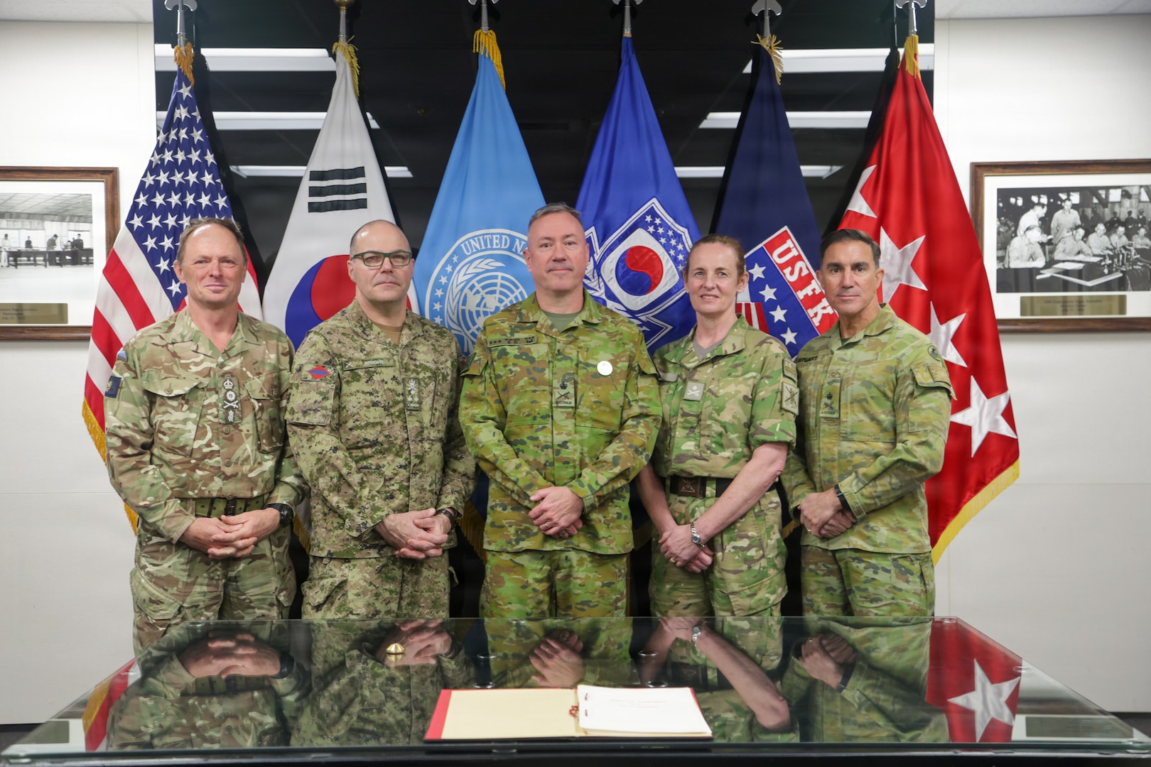 Australian LTGEN Scott Winter, Deputy Commander of the United Nations Command, stands with the visiting Chiefs of Army for a group photo in the Armistice Room after an orientation briefing. The engagement includes Chiefs of Army and Sergeants Major from Australia, Canada, New Zealand, and the United Kingdom during their strategic visit to UNC Headquarters and the Joint Security Area on April 22, 2026.