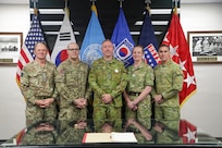 Australian LTGEN Scott Winter, Deputy Commander of the United Nations Command, stands with the visiting Chiefs of Army for a group photo in the Armistice Room after an orientation briefing. The engagement includes Chiefs of Army and Sergeants Major from Australia, Canada, New Zealand, and the United Kingdom during their strategic visit to UNC Headquarters and the Joint Security Area on April 22, 2026.