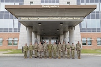 A group photo of the Chiefs of Army and their Sergeants Major standing with UNC and USFK primary staff outside the headquarters building. LTGEN Winter hosts senior Army leaders and Sergeants Major from Australia, Canada, New Zealand, and the United Kingdom during a strategic engagement at UNC Headquarters and the Joint Security Area on April 22, 2026.