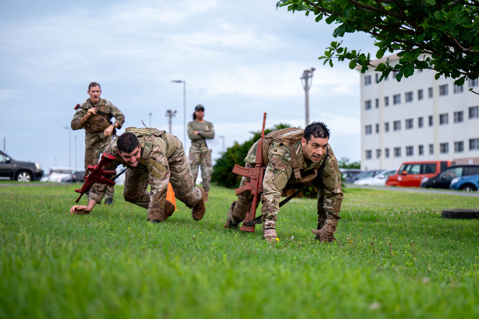 U.S. Air Force Col. Robert Arnett, right, 18th Wing deputy commander, bear-crawls while participating in the Combat Readiness Challenge at Kadena Air Base, Japan, May 15, 2026. The challenge tested participants through a series of physically demanding obstacles designed to reinforce combat readiness, resilience and mission-focused teamwork. (U.S. Air Force photo by Airman 1st Class Nathaniel Jackson)