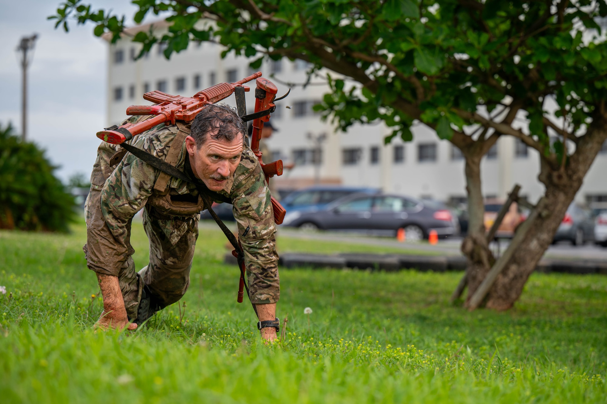 U.S. Air Force Brig. Gen. John Gallemore, 18th Wing commander, bear-crawls while participating in the Combat Readiness Challenge at Kadena Air Base, Japan, May 15, 2026. The challenge highlighted the importance of physical fitness and mental toughness in maintaining mission readiness across the Indo-Pacific. (U.S. Air Force photo by Airman 1st Class Nathaniel Jackson)