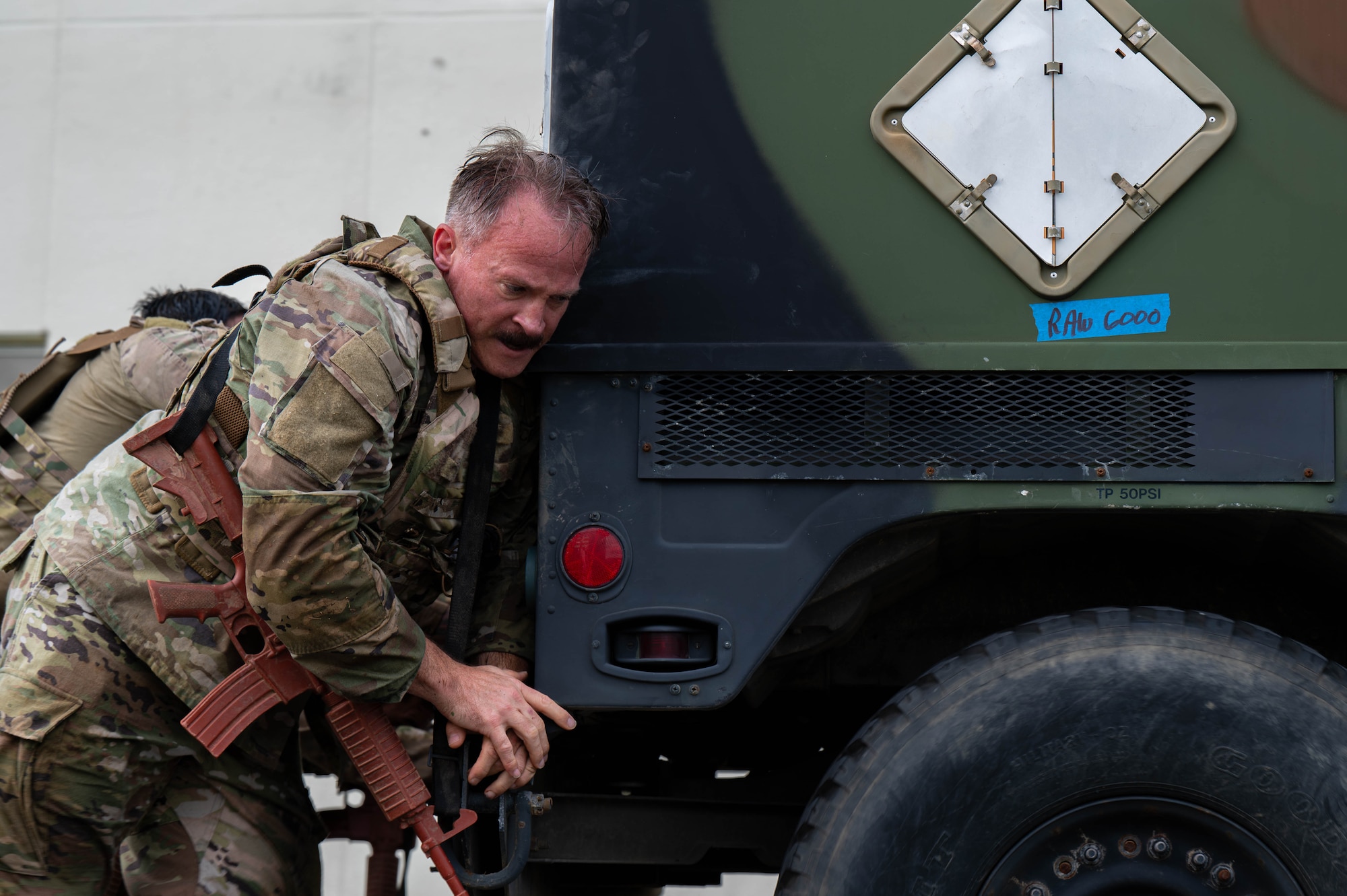 U.S. Air Force Chief Master Sgt. William Cupp, 18th Wing command chief, helps push a vehicle while participating in the Combat Readiness Challenge at Kadena Air Base, Japan, May 15, 2026. The challenge highlighted the importance of physical fitness and mental toughness in maintaining mission readiness across the Indo-Pacific. (U.S. Air Force photo by Airman 1st Class Nathaniel Jackson)