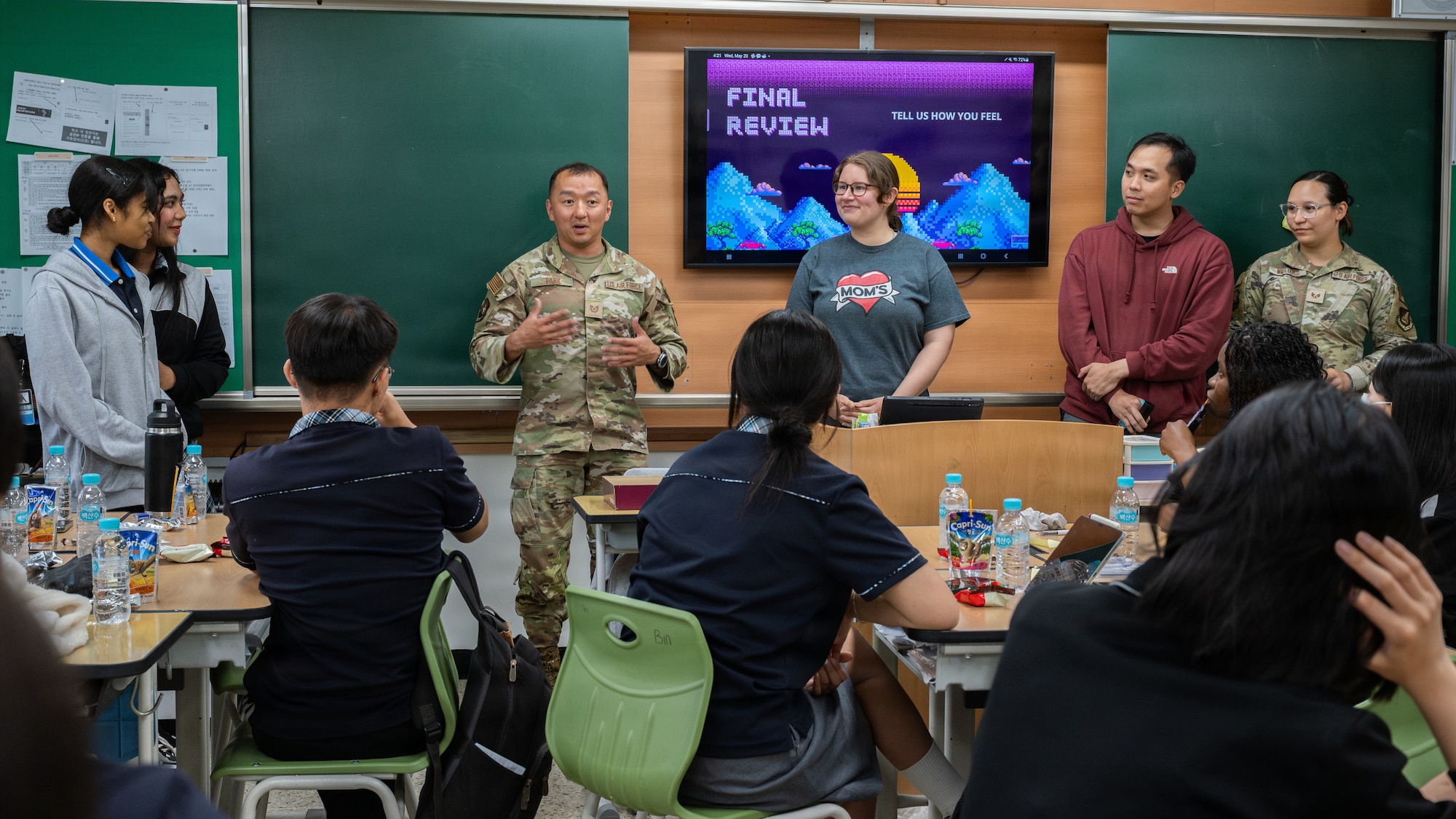 U.S. Airmen speak in front of high school students.