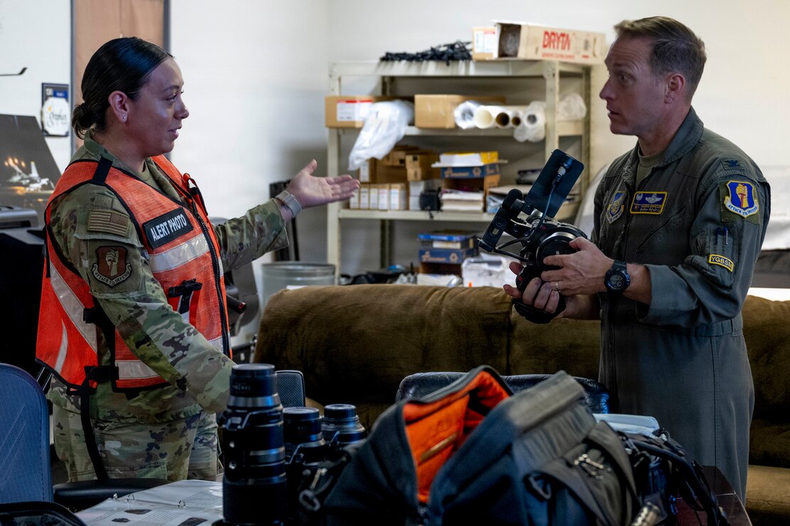 U.S. Air Force Airman 1st Class Jessel Fabara, left, 35th Fighter Wing (FW) Public Affairs specialist, briefs Col. Paul Davidson, 35th FW commander, about equipment she uses during a Wild Weasel Walk-through at Misawa Air Base, Japan, May 18, 2026. (U.S. Air Force photo by Senior Airman Gavin Hameed)
