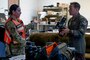 U.S. Air Force Airman 1st Class Jessel Fabara, left, 35th Fighter Wing (FW) Public Affairs specialist, briefs Col. Paul Davidson, 35th FW commander, about equipment she uses during a Wild Weasel Walk-through at Misawa Air Base, Japan, May 18, 2026. (U.S. Air Force photo by Senior Airman Gavin Hameed)