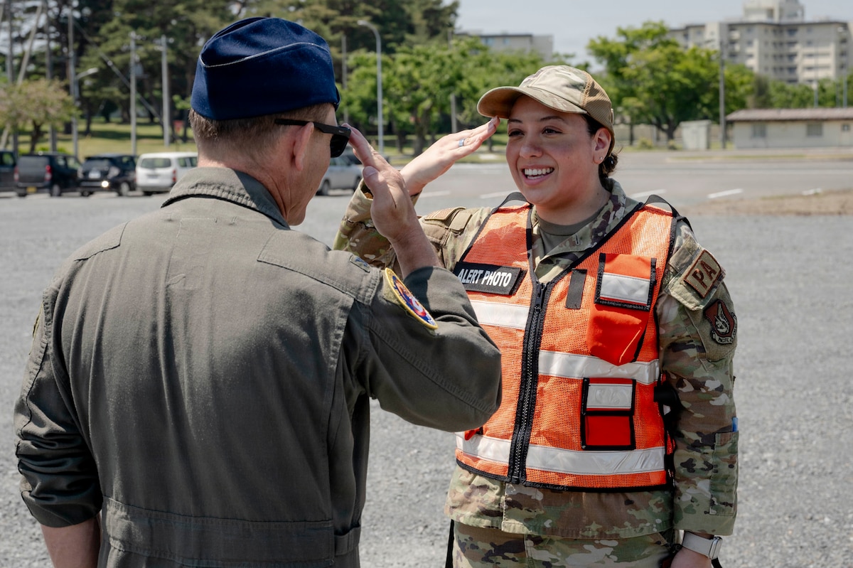 U.S. Air Force Airman 1st Class Jessel Fabara, right, 35th Fighter Wing (FW) Public Affairs specialist, salutes Col. Paul Davidson, 35th FW commander, during a Wild Weasel Walk-through at Misawa Air Base, Japan, May 18, 2026. (U.S. Air Force photo by Senior Airman Gavin Hameed)