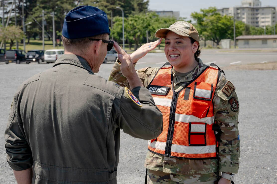 U.S. Air Force Airman 1st Class Jessel Fabara, right, 35th Fighter Wing (FW) Public Affairs specialist, salutes Col. Paul Davidson, 35th FW commander, during a Wild Weasel Walk-through at Misawa Air Base, Japan, May 18, 2026. (U.S. Air Force photo by Senior Airman Gavin Hameed)