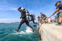 U.S. Navy Seabee divers assigned to Underwater Construction Team (UCT) 1, Construction Dive Detachment Charlie (CDD/C), front step into the water to conduct infrastructure repairs and assessments at the Port Brizine fuel terminal Split, Croatia, May 5, 2026.