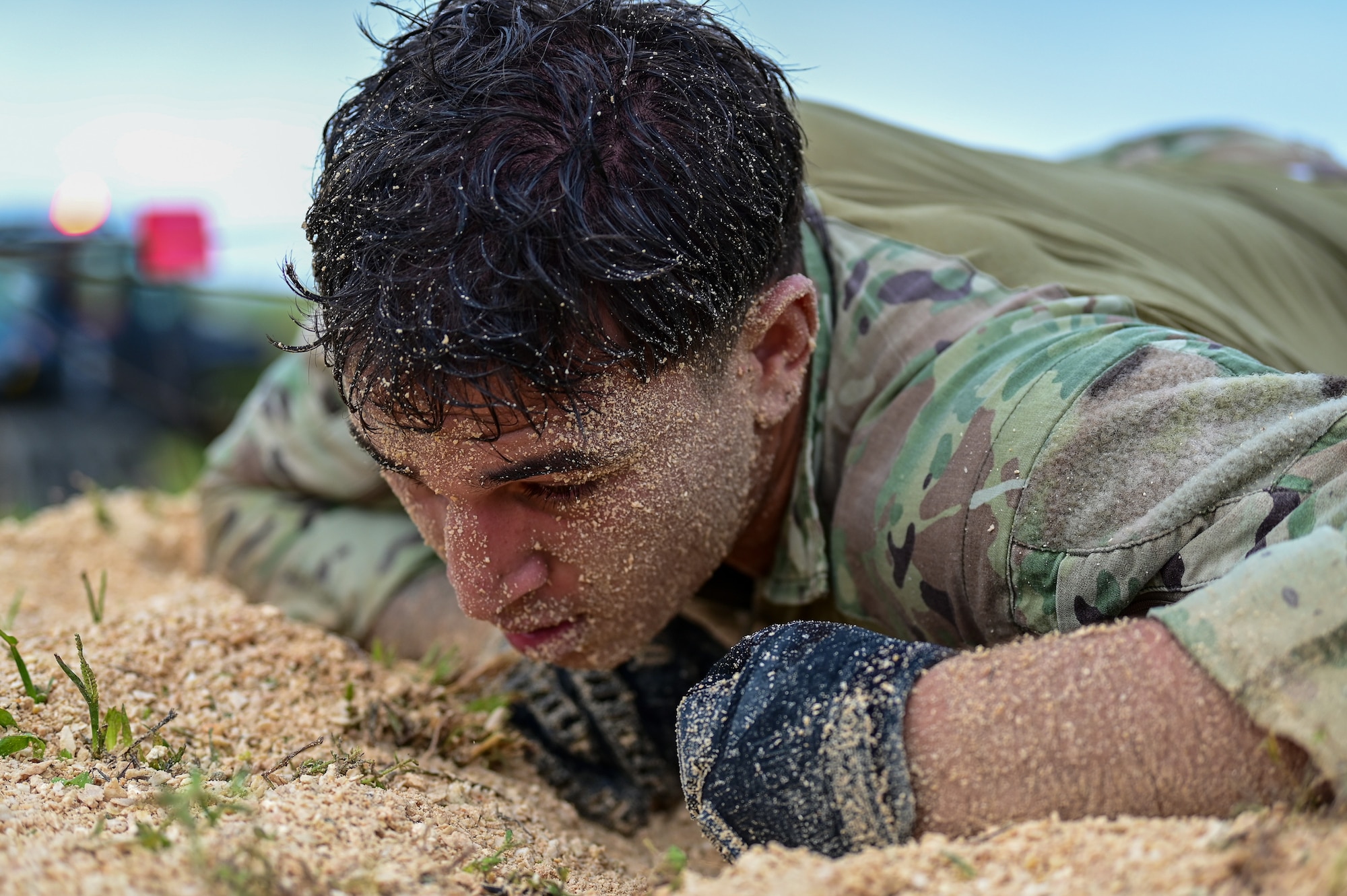 U.S. Senior Airman Anauino Raass, 36th Security Forces Squadron tactical response force assaulter, performs a low crawl during Pacific Air Force’s 9th Annual Advanced Combat Skills Assessment Competition at Northwest Field, Andersen Air Force Base Guam, May 21, 2026.