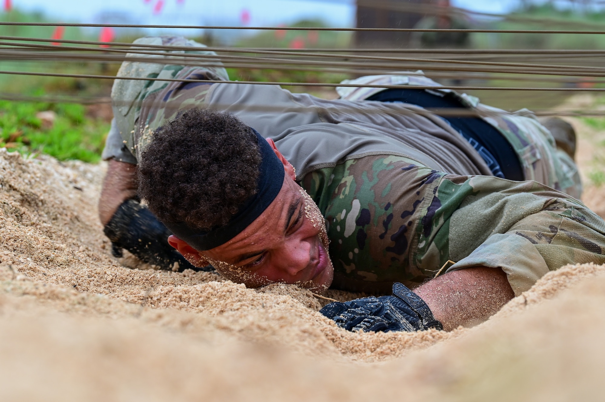 U.S. Air Force Staff Sgt. Richard Maria Perez, 36th Security Forces Squadron counter unmanned aircraft systems program manager, performs a low crawl during Pacific Air Force’s 9th Annual Advanced Combat Skills Assessment Competition at Northwest Field, Andersen Air Force Base Guam, May 21, 2026.
