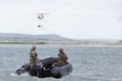 U.S. Army Soldiers, assigned to 961st Engineer Battalion, 420th Engineer Brigade, U.S. Army Reserves, maneuver a combat rubber raiding craft across Lake Belton as U.S. Army Soldiers, assigned to 36th Combat Aviation Brigade, 36th Infantry Division, Texas Army National Guard, sling load improved ribbon bridges from a CH-47 Chinook helicopter in the distance during Operation Hood Strike 26 on Fort Hood, Texas, May 16, 2026. Operation Hood Strike is a large-scale, multi-component engineer exercise on Fort Hood that integrates Active, Reserve, and National Guard Forces through synchronized training to enhance readiness, ensuring a cohesive and deployable total force ready to win in multi-domain operations. (U.S. Army photo by Spc. Breanna Bradford)