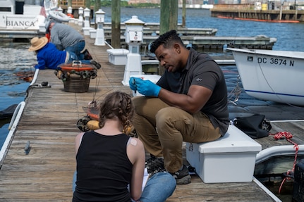 Anthony Gartrell, 11th Civil Engineer Squadron environmental team program manager, measures a mussel during a freshwater mussel deployment event at Joint Base Anacostia-Bolling, Washington, D.C., May 15, 2026. Freshwater mussels serve as natural biological filtration systems; a single mussel can filter gallons of water daily, removing algae, bacteria, and particulates from the water column.(U.S. Air Force photo by Senior Airman Shanel Toussaint)
