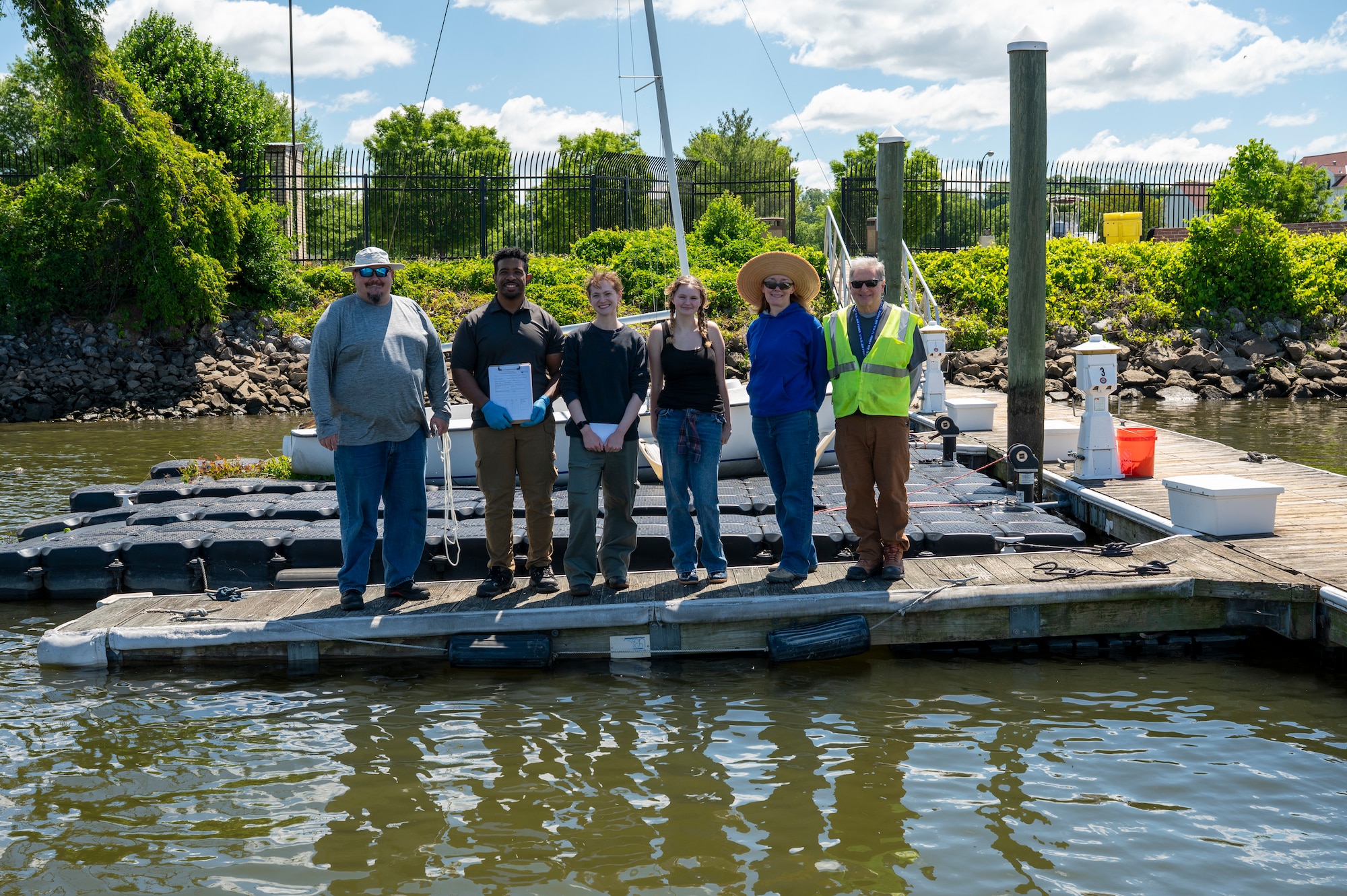 Members of the 11th Civil Engineer Squadron Civil Engineer Installation Environmental team stand on the marina dock after a freshwater mussel deployment event at Joint Base Anacostia-Bolling, Washington, D.C., May 15, 2026. To ensure the success of the nursery, the 11th CES conducts recurring biometric assessments and all gathered data is reported to the Anacostia Watershed Society to support regional environmental research and restoration tracking. (U.S. Air Force photo by Senior Airman Shanel Toussaint)