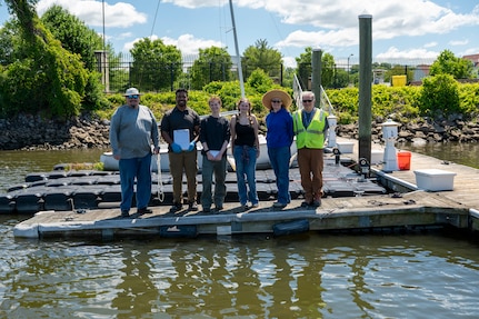 Members of the 11th Civil Engineer Squadron Civil Engineer Installation Environmental team stand on the marina dock after a freshwater mussel deployment event at Joint Base Anacostia-Bolling, Washington, D.C., May 15, 2026. To ensure the success of the nursery, the 11th CES conducts recurring biometric assessments and all gathered data is reported to the Anacostia Watershed Society to support regional environmental research and restoration tracking. (U.S. Air Force photo by Senior Airman Shanel Toussaint)