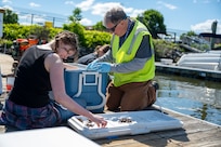 Emma Schuldt, a student volunteer assisting the 11th Civil Engineer Squadron, (left) and Michael Hooks, environmental team member, count mussels in preparation for freshwater mussel deployment event at Joint Base Anacostia-Bolling, Washington, D.C., May 15, 2026. These nurseries create a more resilient ecosystem, directly benefiting native wildlife and the overall health of the Potomac River by removing algae, bacteria, and particulates from the water column. (U.S. Air Force photo by Senior Airman Shanel Toussaint)