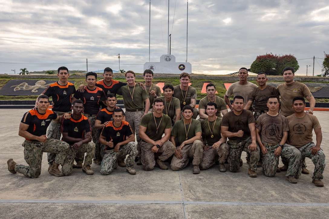 U.S. Marines with Light Armored Reconnaissance Company, Battalion Landing Team 3/6, 22nd Marine Expeditionary Unit (Special Operations Capable), and Ecuadorian Marines pose for a group photo during a bilateral exercise on Naval Base Jaramijó, Ecuador, April 30, 2026. The 22nd MEU (SOC)’s Ecuador bilateral training enhances interoperability with partner forces, reinforces longstanding security relationships, and improves combined readiness to respond to crises across the region. U.S. military forces are deployed to the region in support of U.S. Southern Command mission objectives and the president’s priorities to strengthen regional security, disrupt illicit drug trafficking, and protect the U.S. homeland. (U.S. Marine Corps photo)