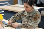U.S. Air National Guard Tech. Sgt. Fernanda Van Pratt, 162nd Aircrew Flight Equipment, or AFE, noncommissioned officer in charge, stitches a parachute at Morris Air National Guard Base, Arizona, May 1, 2026. During a major vertical inspection the 162nd AFE flight earned a top-tier rating, leading the inspector to share their modernized mobility deployment kits with Air National Guard units nationwide, enhancing mission adaptability across the force. Photo by Tech. Sgt. Hampton Stramler.