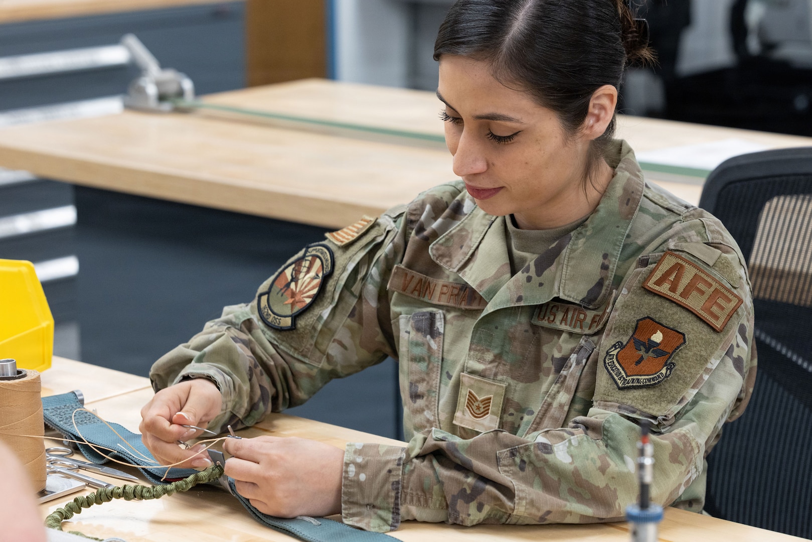 U.S. Air National Guard Tech. Sgt. Fernanda Van Pratt, 162nd Aircrew Flight Equipment, or AFE, noncommissioned officer in charge, stitches a parachute at Morris Air National Guard Base, Arizona, May 1, 2026.