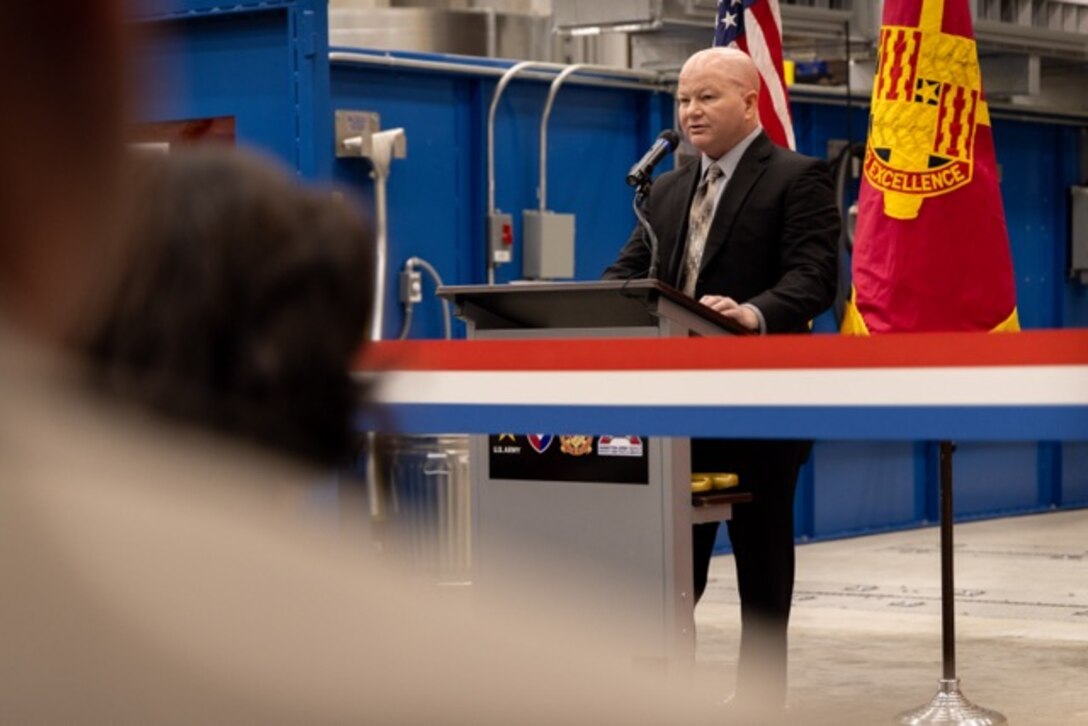 Picture of a man speaking at a podium.