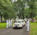 Sailors from the Navy Reserve Center Indianapolis and Naval Station Great Lakes, along with Rear Adm. Michael Richman, the deputy Portfolio Acquisition Executive (PAE) Strategic Systems Programs (SSP) for regional deterrence, salute the motorcade carrying Seaman 1st Class Wayne Edward Newton at Grandview Cemetery in Terre Haute, Ind., on May 16, 2026. 

Newton was killed in action on Dec. 7, 1941, during the attack on Pearl Harbor, while serving on USS California (BB-44), a Tennessee-class battleship. Newton’s remains were recently identified by the Defense POW/MIA Accounting Agency as part of the USS California Project, a forensic research and recovery initiative aiming to identify 25 previously unidentified Sailors and Marines killed in the attack. In the time-honored tradition of military funerals, Richman presented the folded American flag to Newton’s next of kin, his nephew Mr. Stephen Newton.
