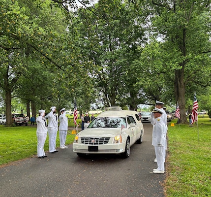 Sailors from the Navy Reserve Center Indianapolis and Naval Station Great Lakes, along with Rear Adm. Michael Richman, the deputy Portfolio Acquisition Executive (PAE) Strategic Systems Programs (SSP) for regional deterrence, salute the motorcade carrying Seaman 1st Class Wayne Edward Newton at Grandview Cemetery in Terre Haute, Ind., on May 16, 2026. 

Newton was killed in action on Dec. 7, 1941, during the attack on Pearl Harbor, while serving on USS California (BB-44), a Tennessee-class battleship. Newton’s remains were recently identified by the Defense POW/MIA Accounting Agency as part of the USS California Project, a forensic research and recovery initiative aiming to identify 25 previously unidentified Sailors and Marines killed in the attack. In the time-honored tradition of military funerals, Richman presented the folded American flag to Newton’s next of kin, his nephew Mr. Stephen Newton.