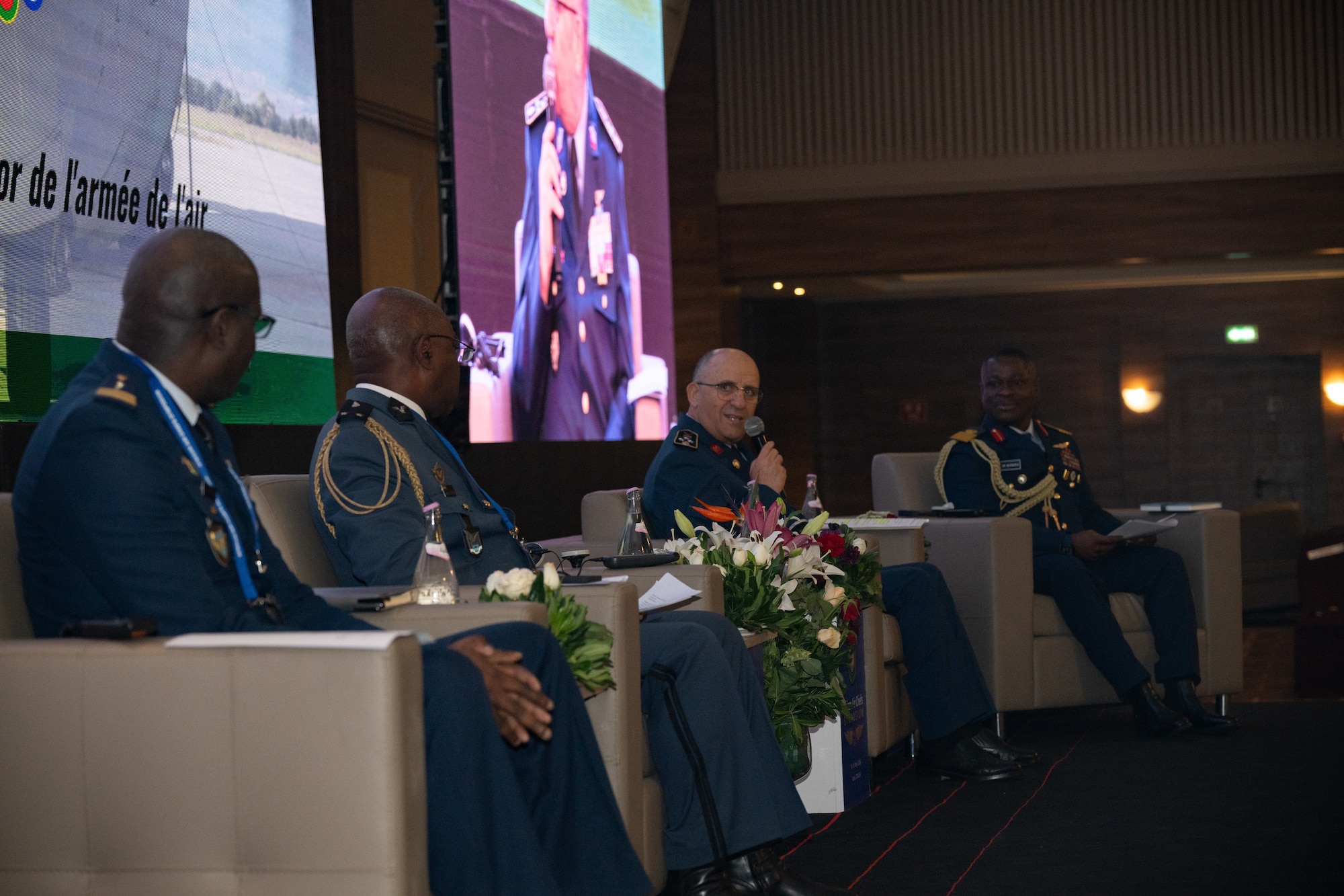 A panel speaks on a stage