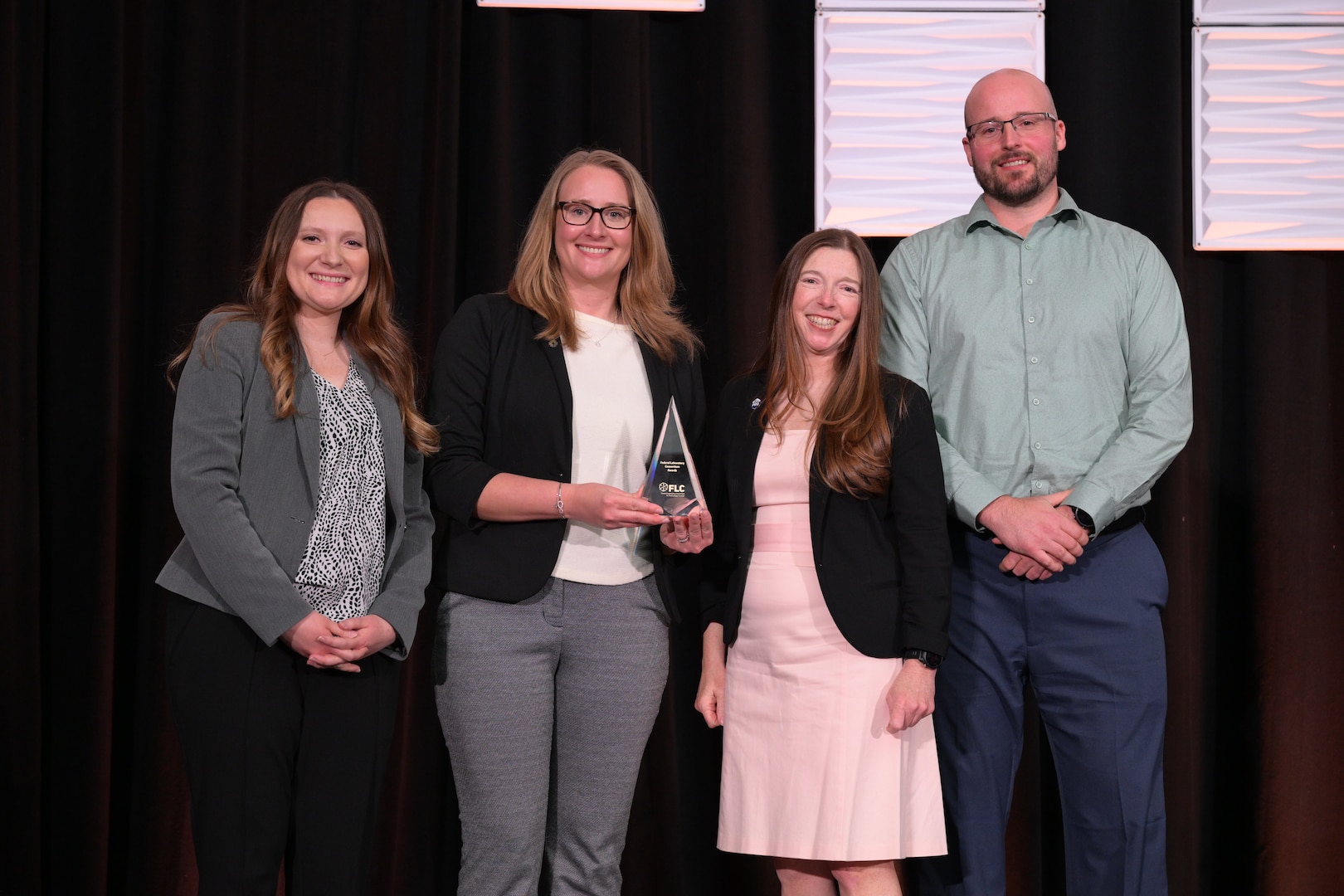 Amanda McCullough, Technological Transfer Agreements Program Manager at NSWC Crane (pictured left), at the awards ceremony for 2026 Technology Transfer Rookie of the Year Award.