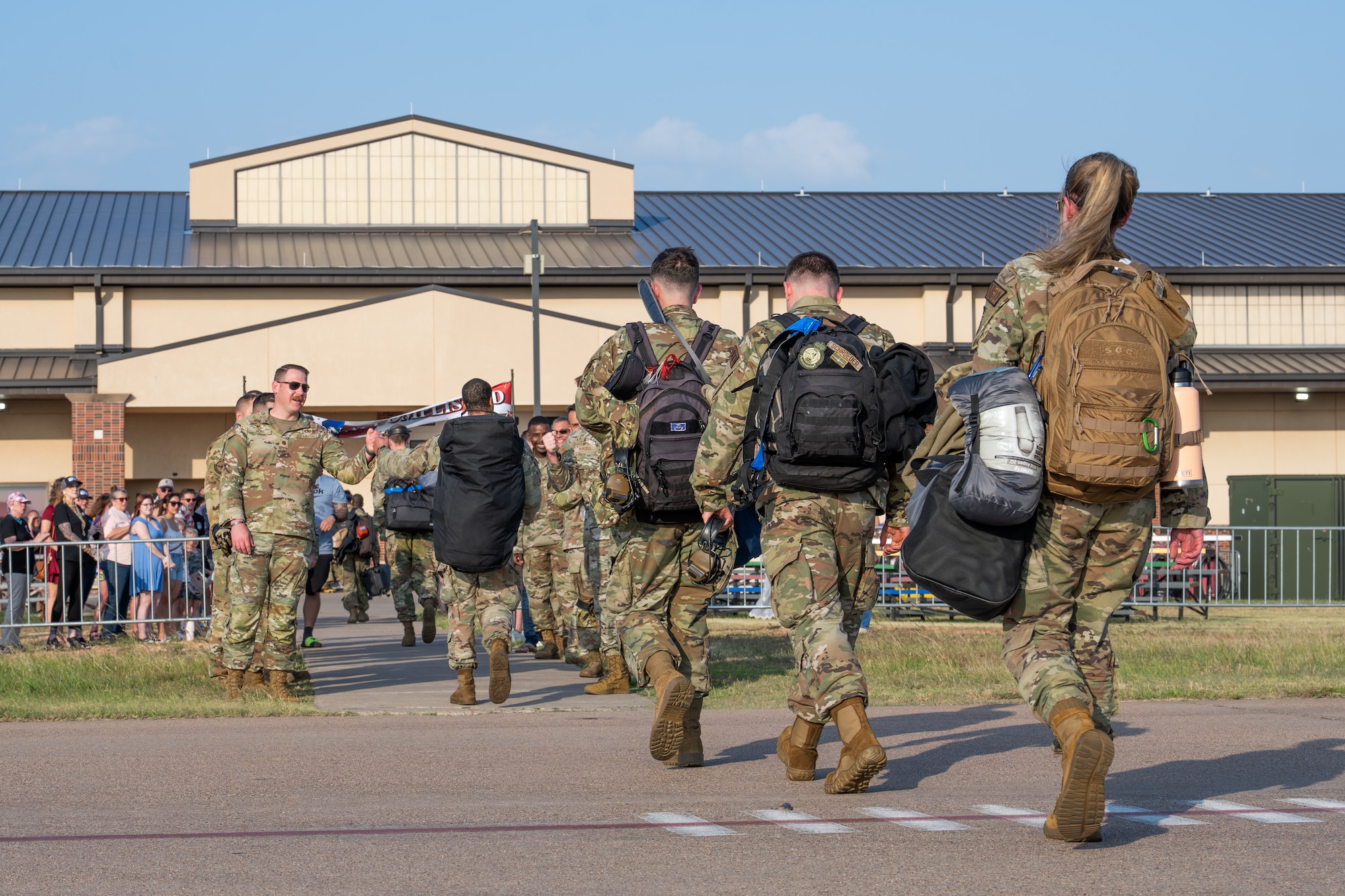 U.S. Airmen assigned to the 317th Airlift Wing reunite with their teammates after returning home from a deployment at Dyess Air Force Base, Texas, May 18, 2026. As the operator of the largest C-130J flight hour program in the Air Force, the 317th AW maintains high-level readiness to project combat airpower into joint and combined environments globally. (U.S. Air Force photo by Airman 1st Class Caleb Schellenberg)