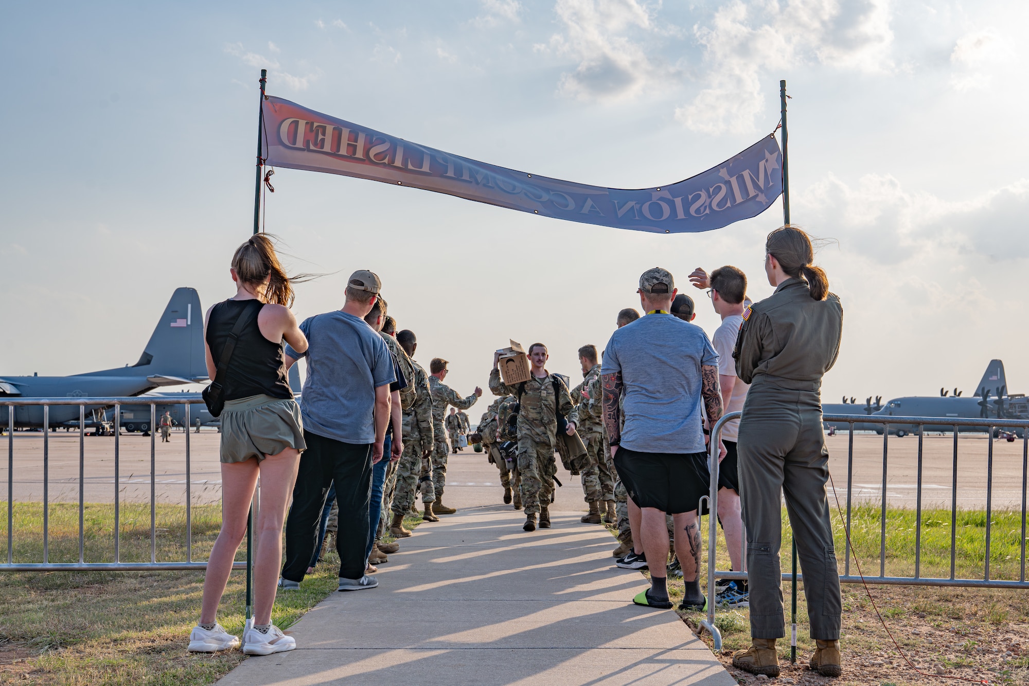 U.S. Airmen assigned to the 317th Airlift Wing are welcomed back from a deployment at Dyess Air Force Base, Texas, May 18, 2026. The 317th AW provides critical tactical airlift, airdrop and aeromedical evacuation capabilities, ensuring the rapid movement of personnel and equipment to meet global contingency requirements. (U.S. Air Force photo by Airman 1st Class Caleb Schellenberg)