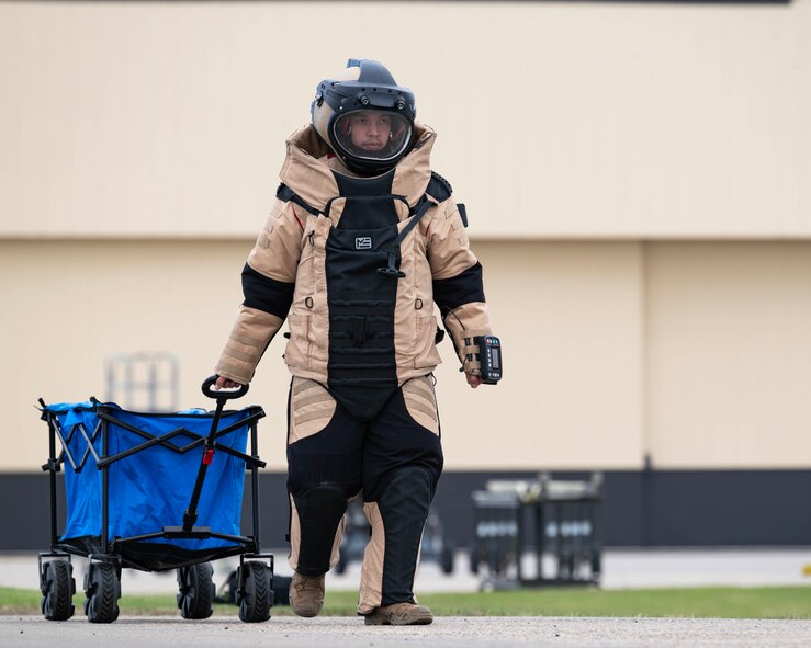 U.S. Air Force Staff Sgt. Benjamin Sherva, 5th Civil Engineer Squadron explosive ordnance disposal (EOD) team member, transports EOD equipment during Warbird Week at Minot Air Force Base, North Dakota, May 14, 2026. Sherva disarmed and defeated simulated explosives as part of Warbird Week. (U.S. Air Force photo by Senior Airman Kyle Wilson)