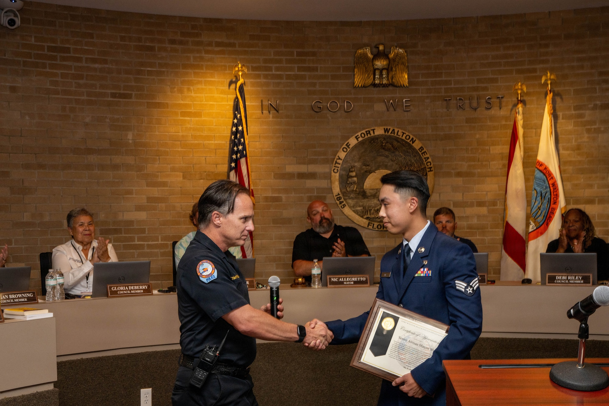 Chief of police shakes airman hand