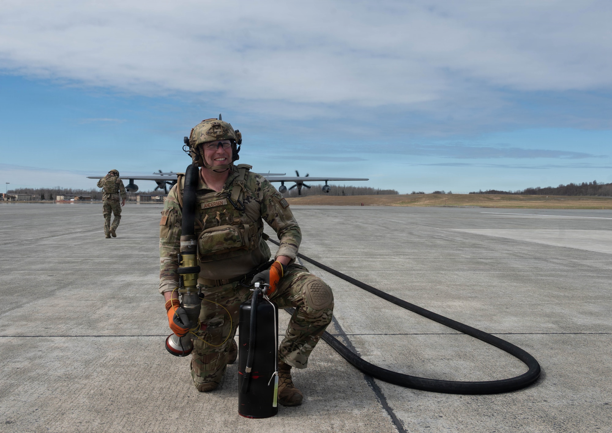 U.S. Air Force Tech. Sgt. Devan Andersen, 176th Logistics Readiness Squadron noncommissioned officer in charge of fuels distribution, shoulders a refueling hose while waiting for aircraft during a forward arming and refueling point operation at Joint Base Elmendorf-Richardson, Alaska, May 15, 2026.
