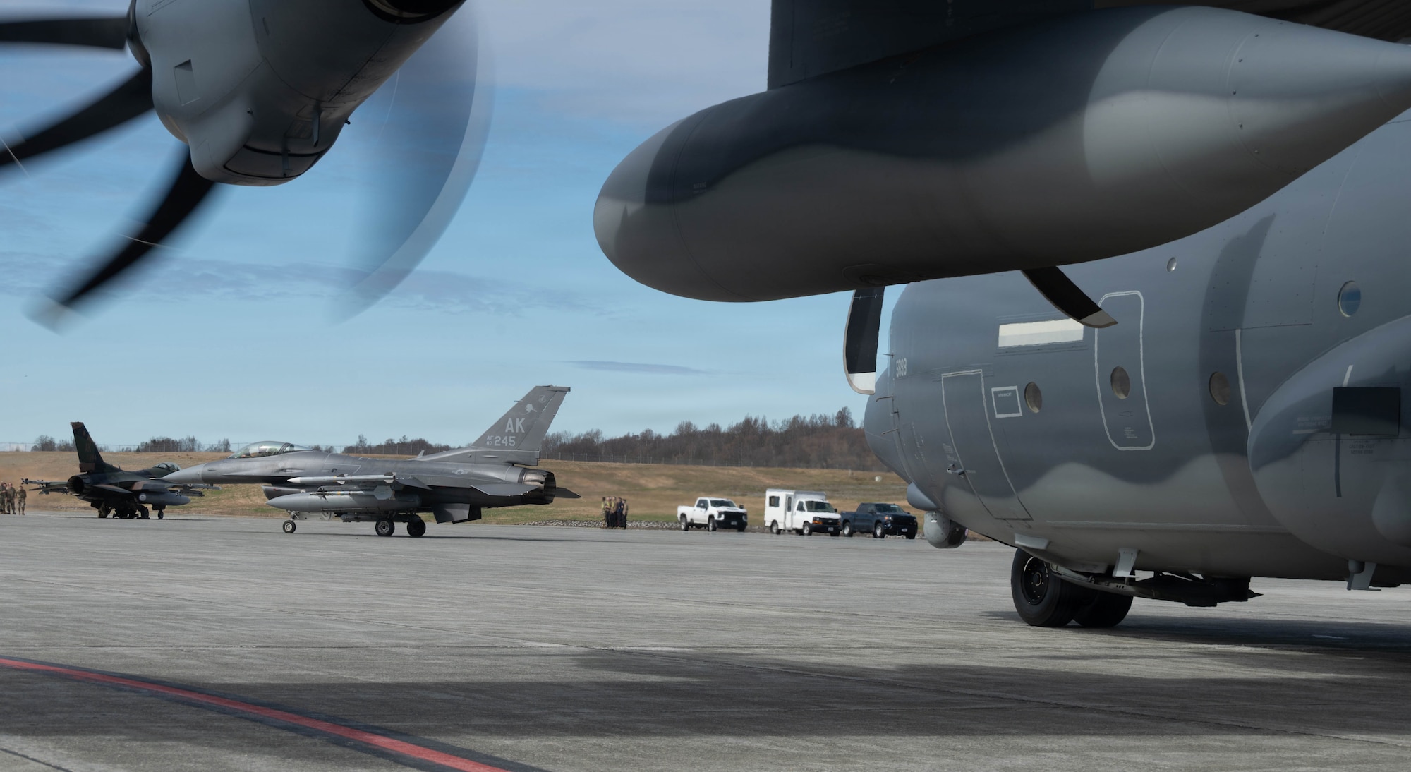 U.S. Air Force F-16 Fighting Falcons, assigned to the 18th Fighter Interceptor Squadron, taxis prior to refueling from a HC-130J Combat King II assigned to the 211th Rescue Squadron, during a forward arming and refueling point operation at Joint Base Elmendorf-Richardson, Alaska, May 15, 2026.
