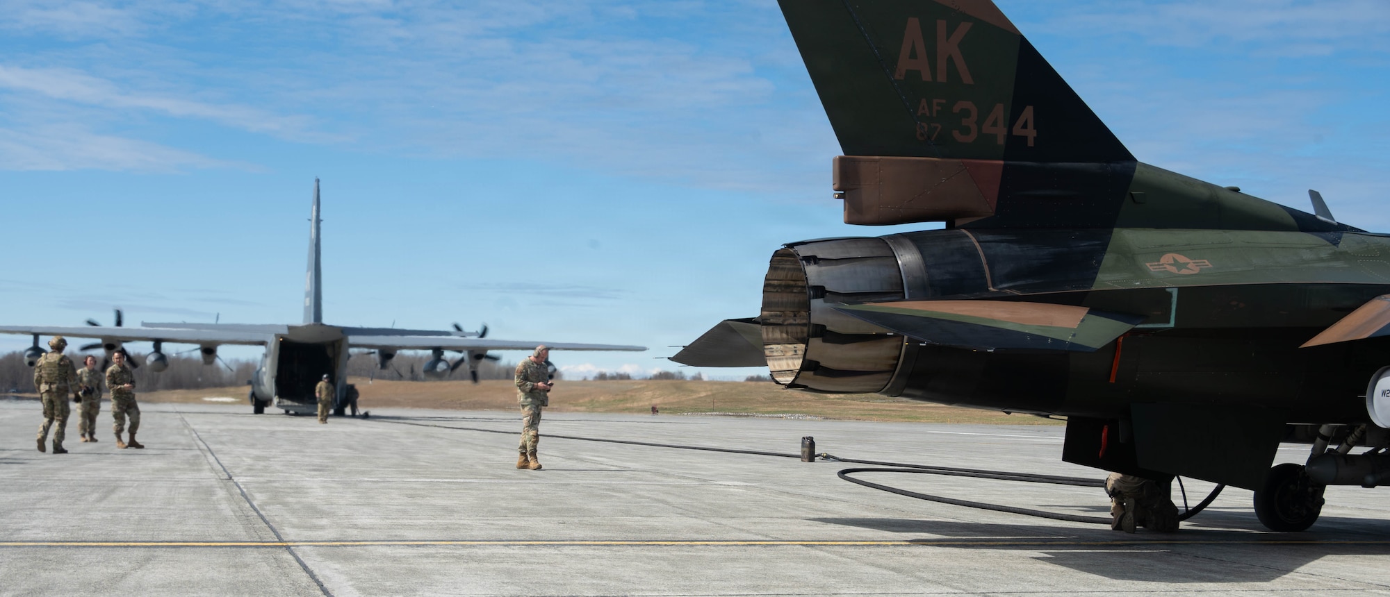 A U.S. Air Force F-16 Fighting Falcon assigned to 18th Fighter Interceptor Squadron is connected for refueling from a HC-130J Combat King II assigned to the 211th Rescue Squadron, during a forward arming and refueling point operation at Joint Base Elmendorf-Richardson, Alaska, May 15, 2026.
