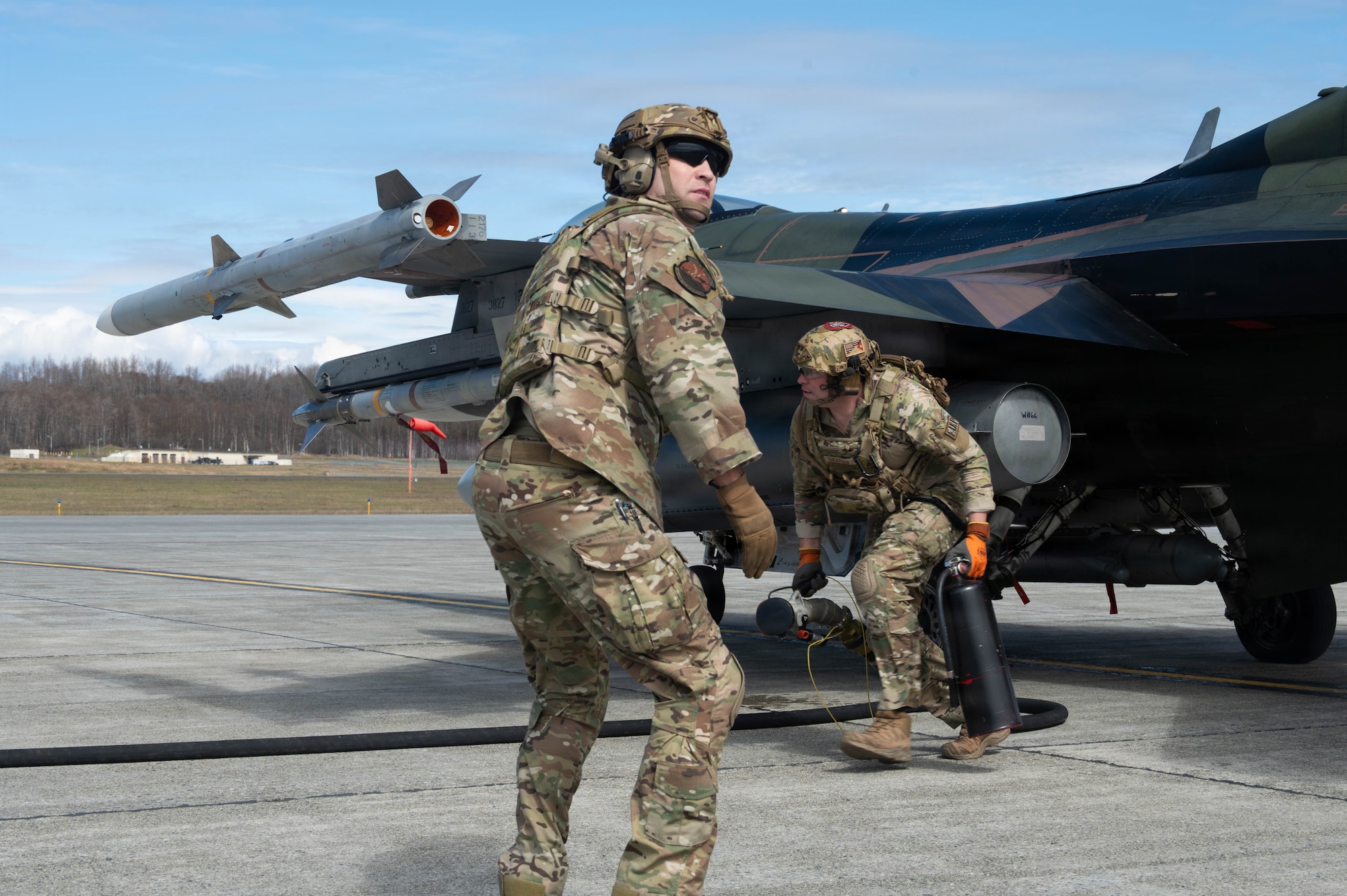 U.S. Air Force Master Sgt. Tyler Vasquez, left, 176th Logistics Readiness Squadron fuels management specialist, and U.S. Air Force Tech. Sgt. Devan Andersen, 176th LRS noncommissioned officer in charge of fuels distribution, disconnect and prepare for a second refueling during a forward arming and refueling point operation at Joint Base Elmendorf-Richardson, Alaska, May 15, 2026.